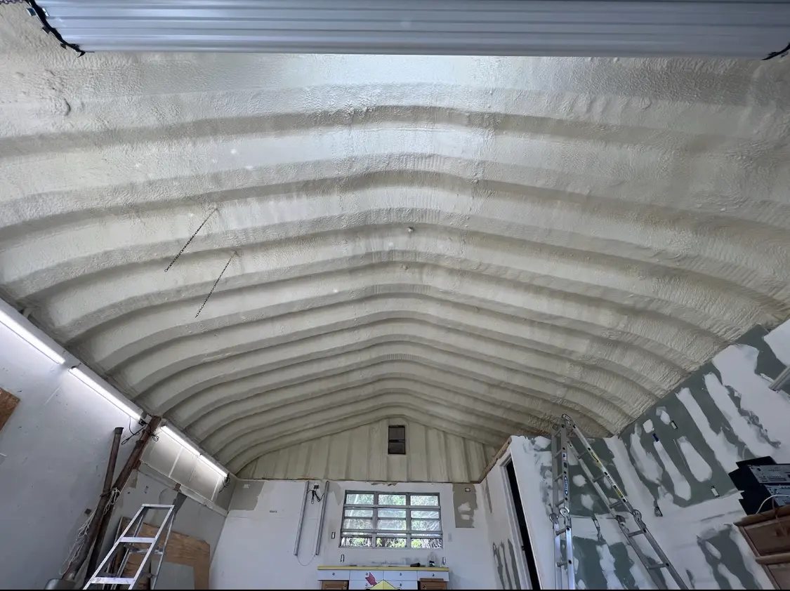 Spray polyurethane foam applied to the underside of a metal roof deck in Westfield